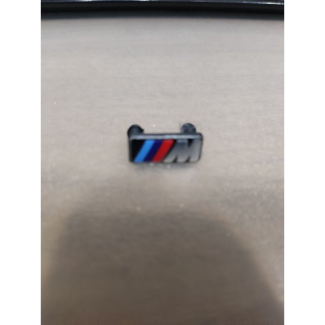 steering wheel M badge holder — source image